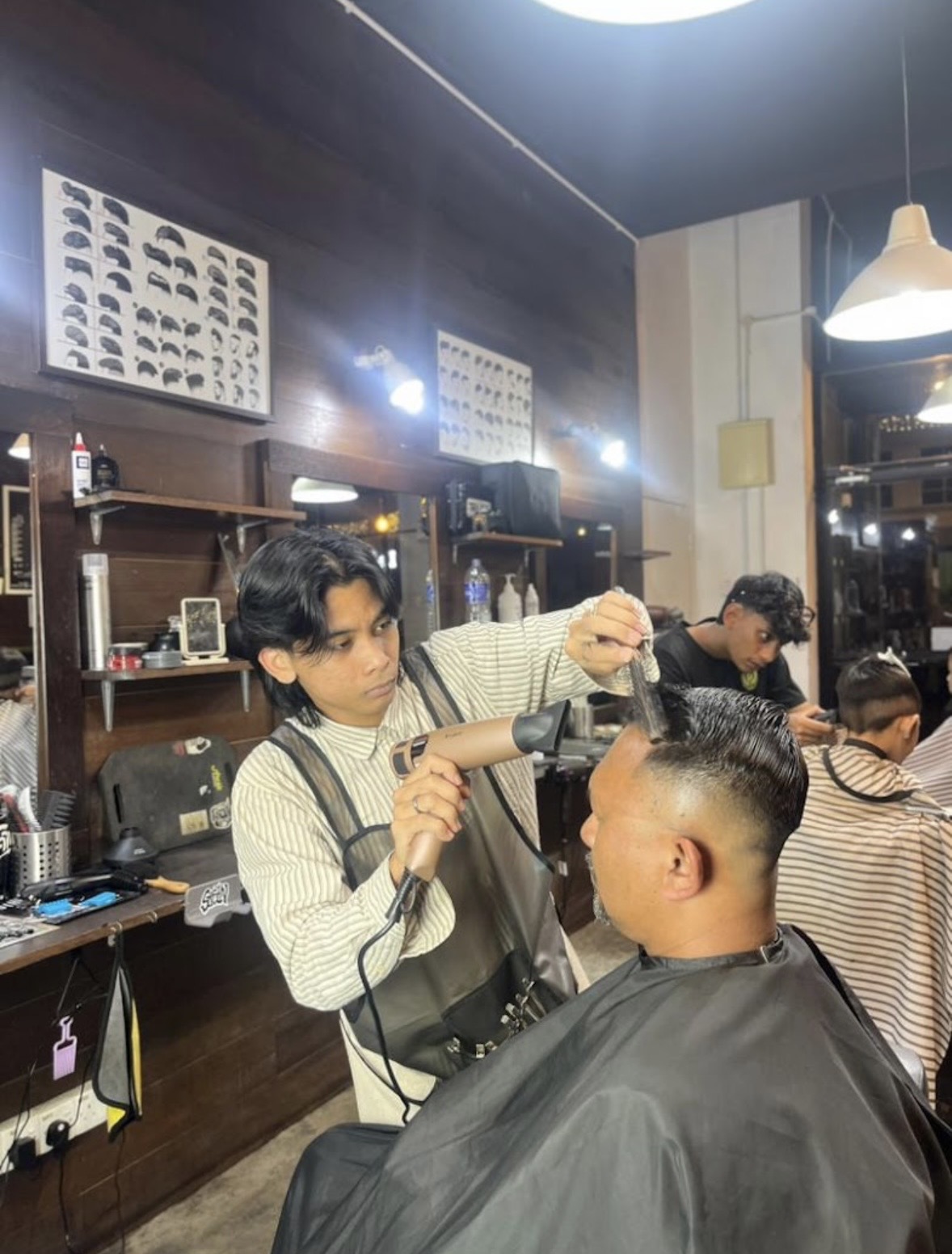 Madz barber cutting hair inside the shop