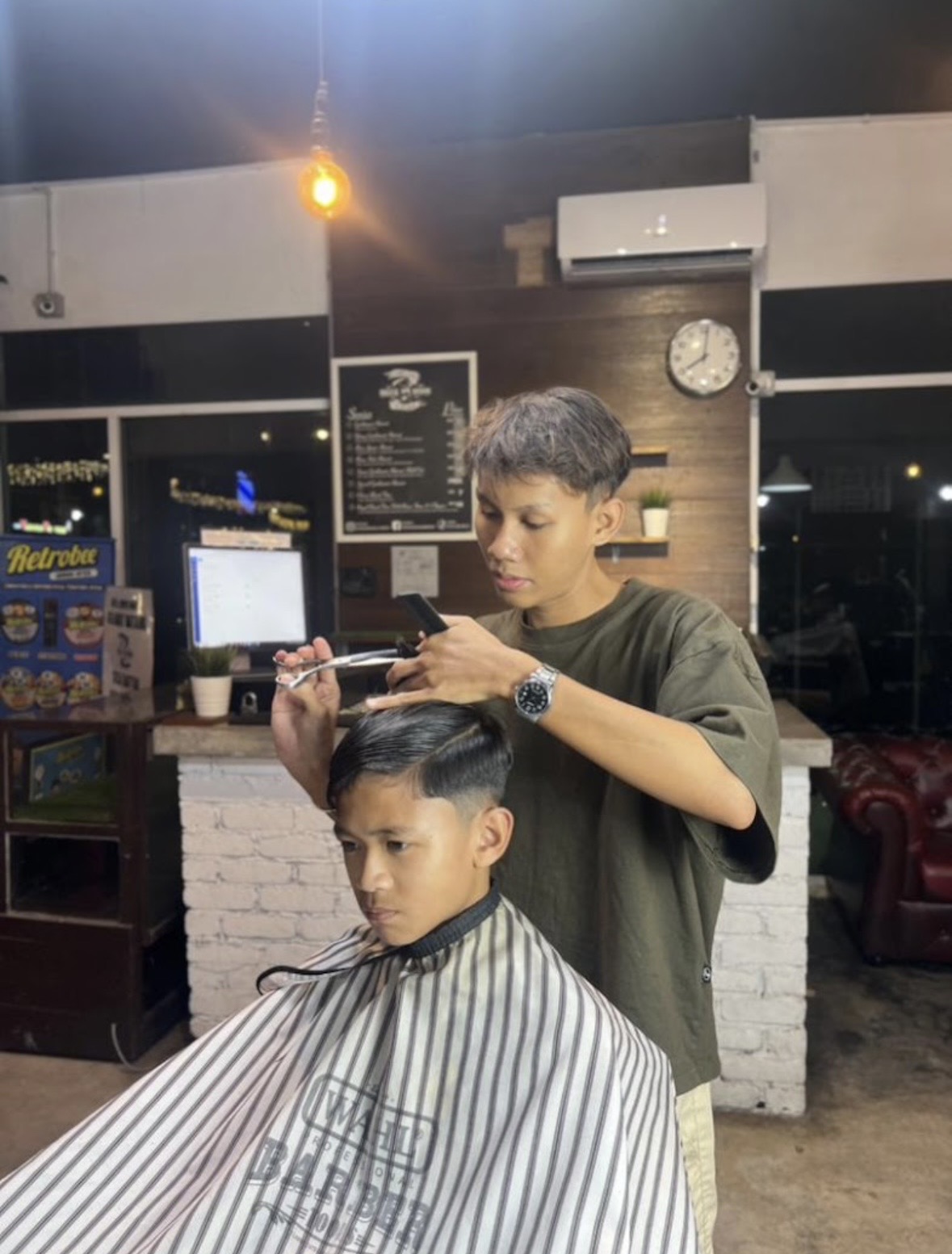 Madz barber styling a client
